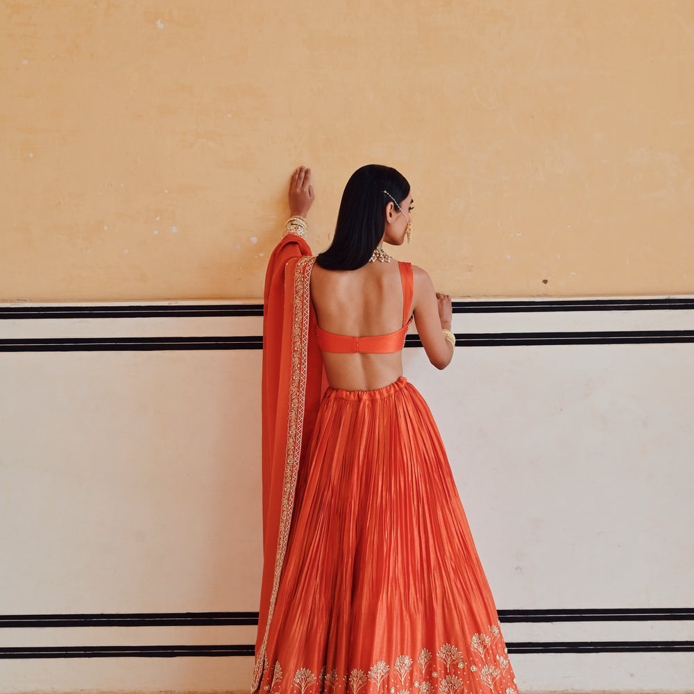 
                      
                        ORANGE BROAD STEP EMBROIDERED BLOUSE WITH BUTTI EMBROIDERED LEHENGA AND DUPATTA
                      
                    