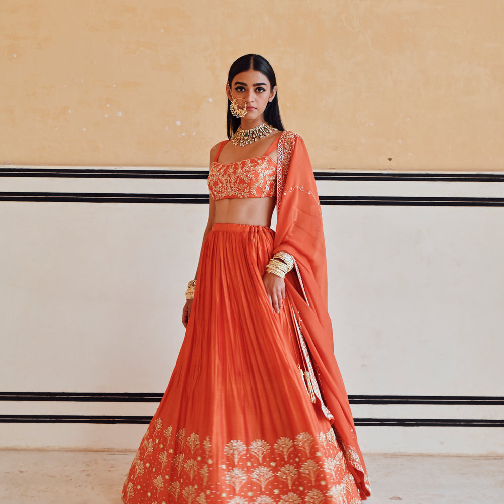 
                      
                        ORANGE BROAD STEP EMBROIDERED BLOUSE WITH BUTTI EMBROIDERED LEHENGA AND DUPATTA
                      
                    