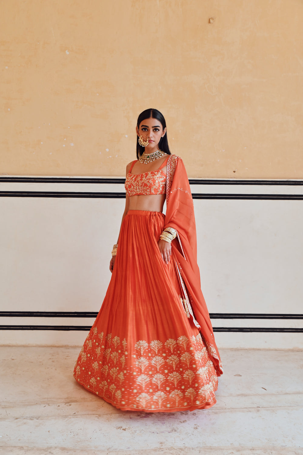 ORANGE BROAD STEP EMBROIDERED BLOUSE WITH BUTTI EMBROIDERED LEHENGA AND DUPATTA