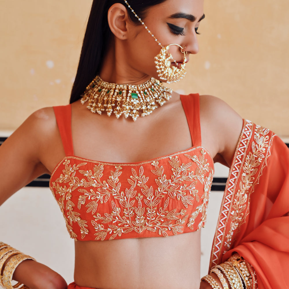 
                      
                        ORANGE BROAD STEP EMBROIDERED BLOUSE WITH BUTTI EMBROIDERED LEHENGA AND DUPATTA
                      
                    