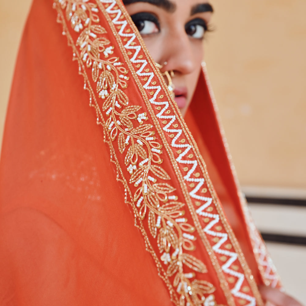 
                      
                        ORANGE BROAD STEP EMBROIDERED BLOUSE WITH BUTTI EMBROIDERED LEHENGA AND DUPATTA
                      
                    