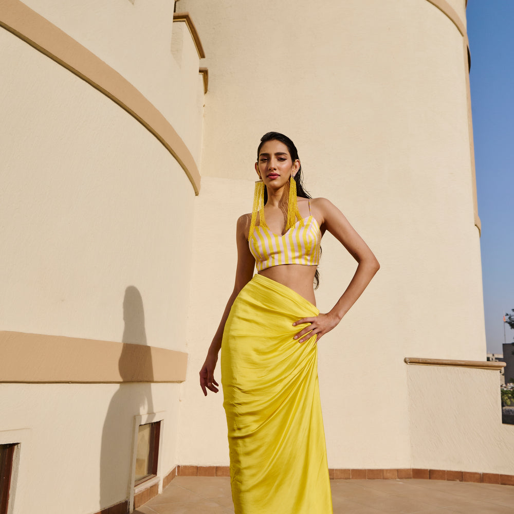 
                      
                        YELLOW STRIPED JACKET WITH DRAPED SKIRT AND BRALETTE
                      
                    